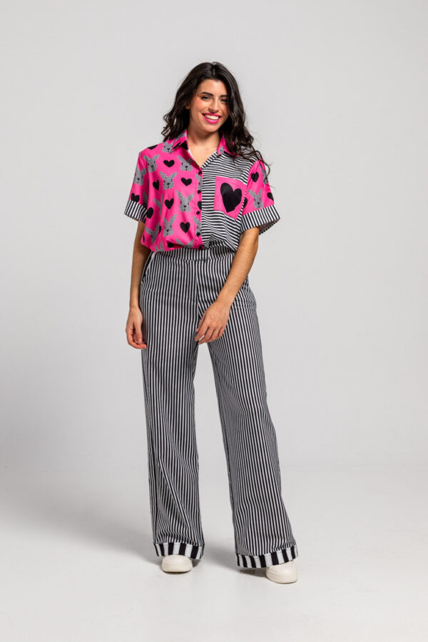 Camisa unisex en rosa y con estampado de corazones y conejos con detalle en la espalda con un gran conejo en rayas blanco y negro. También puedes encontrarlo en nuestra tienda física en el Casco Antiguo de Badajoz