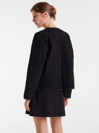Chaqueta de pana negra con cuello pico, hombro caído, bolsillos laterales y cierre de botones a presión. Disponible en Dulce Locura, tienda de moda en Badajoz.